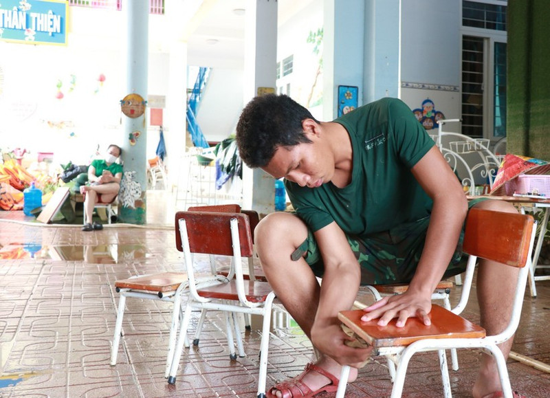 Fuerzas combinadas de la policía, el ejército, profesores y jóvenes voluntarios colaboran en la limpieza de las escuelas para acelerar el retorno a las aulas. (Foto: VNA)
