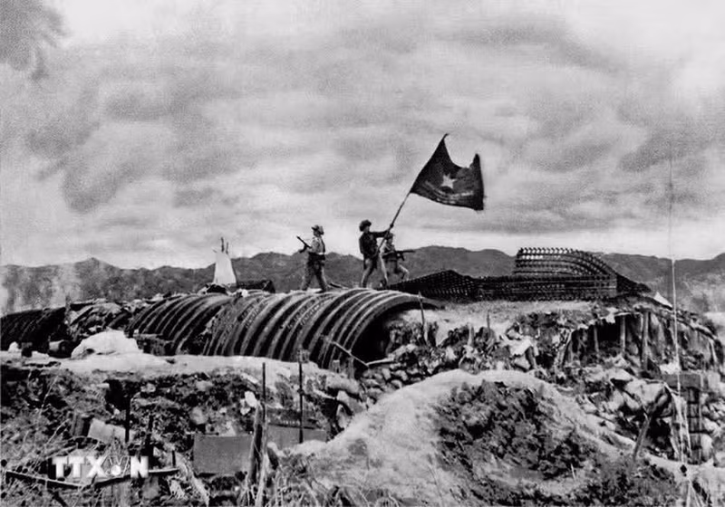 La bandera "Decididos a luchar, decididos a vencer" del Ejército Popular Vietnamita ondea sobre el búnker del general francés De Castries.