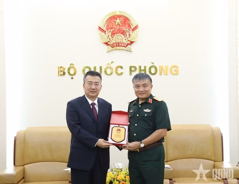 El viceministro de Defensa de Vietnam, Nguyen Van Hien (derecha), intercambia un obsequio con Lyu Wuqin, asistente del ministro de Seguridad Pública de China. (Foto: qndn.vn)