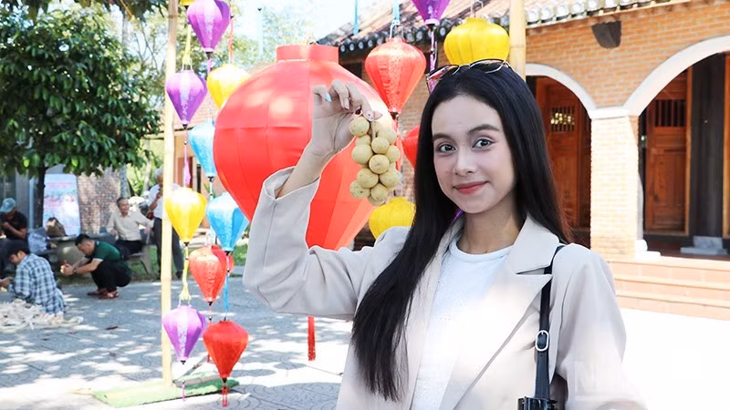 Los visitantes degustan una fruta característica de la antigua aldea de Loc Yen. (Foto: Anh Quan)