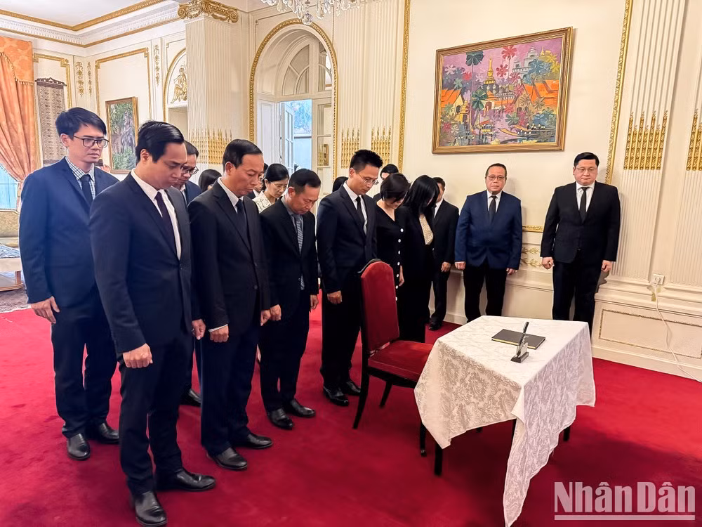 El encargado de negocios interino Pham Quang Anh, funcionarios de la Embajada y representantes de entidades vietnamitas en Francia guardan un minuto de silencio en memoria del camarada Saysomphone Phomvihane. (Foto: Trung Hung).