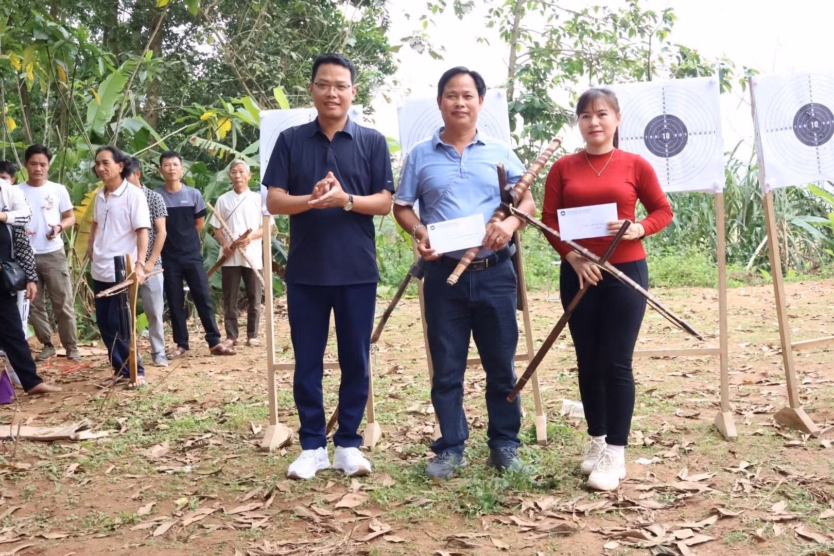 El director del Centro de Servicios Generales de la comuna de Ba Vi, Tran Thanh Dung, entrega premios a los atletas con logros destacados en la competición de tiro con ballesta.