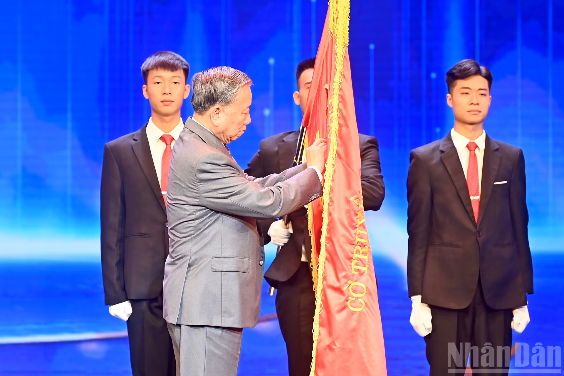  El secretario general To Lam coloca la Orden del Trabajo de primera clase en la bandera tradicional de la Televisión de Vietnam.