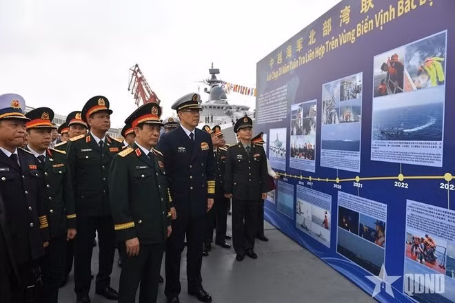 Los oficiales visitan una exposición fotográfica sobre patrullas conjuntas realizadas anteriormente entre las dos Armadas. (Foto: qdnd.vn)