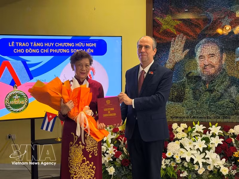 El embajador de Cuba en Vietnam, Rogelio Polanco Fuentes, entrega la Medalla de Amistad a Phuong Song Lien, vicepresidenta de la Asociación de Amistad Vietnam-Cuba y titular del Club de Estudiantes Vietnamitas Graduados en Cuba. (Fuente: VNA)