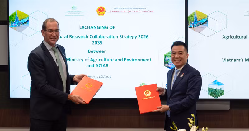 El doctor Nick Austin, director ejecutivo en funciones del ACIAR, y el viceministro de Agricultura y Medio Ambiente de Vietnam Dang Ngoc Diep intercambian ejemplares de la Estrategia de Cooperación en Investigación Agrícola 2026-2035, en Canberra, el 11 de agosto de 2026. (Foto: ACIAR)