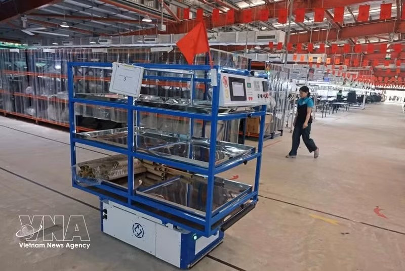 Los robots transportan automáticamente materiales del almacén a la línea de producción de Maxport Limited Vietnam (Foto: VNA)