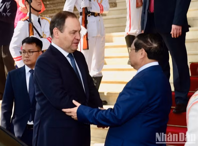Pham Minh Chinh y Roman Golovchenko tras la ceremonia.