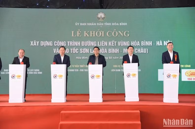 Minh Chinh y los delegados presionan el botón para iniciar la construcción de los proyectos viales.