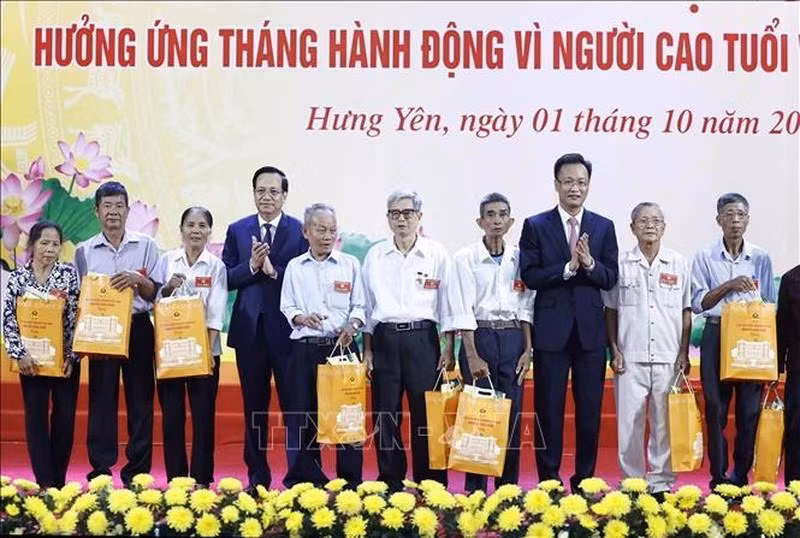 El ministro de Trabajo, Inválidos de Guerra y Asuntos Sociales, Dao Ngoc Dung, y Nguyen Huu Nghia otorgan regalos a personas de tercera edad en circunstancias difíciles.