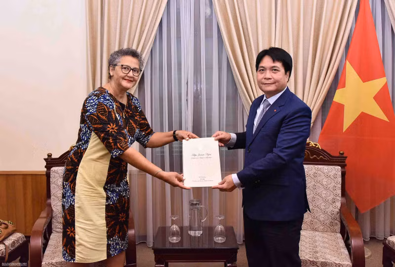 El jefe del Departamento de Protocolo del Ministerio de Relaciones Exteriores de Vietnam, Nguyen Viet Dung, recibe copias de las credenciales de la embajadora de Mozambique, Ilundi Dos Santos. (Fotografía: baoquocte.vn)