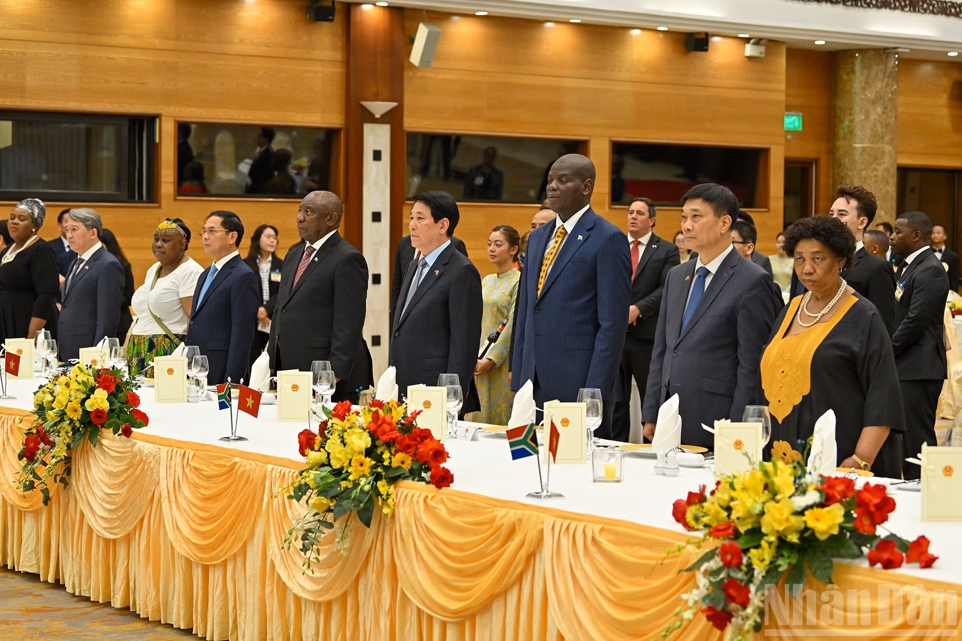 El presidente Luong Cuong y su homólogo sudafricano Matamela Cyril Ramaphosa, junto con los delegados, escuchan la interpretación de los himnos nacionales de ambos países.