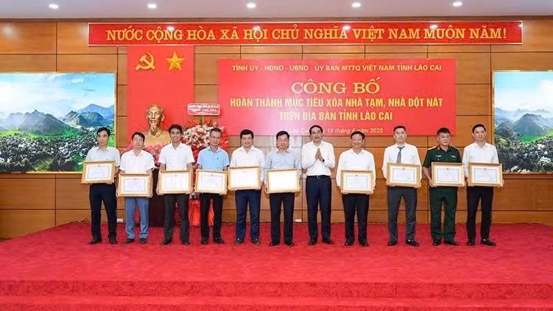 El secretario del Comité del Partido de la provincia de Lao Cai, Trinh Xuan Truong, otorga Certificados de Mérito a las entidades y localidades con logros sobresalientes en la eliminación de viviendas temporales y deterioradas. (Foto: Nhan Dan)