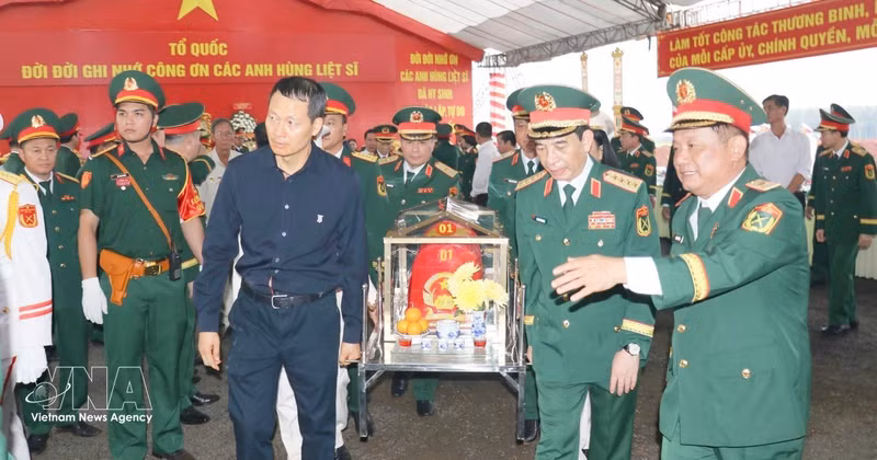 El general Phan Van Giang, miembro del Buró Político, viceprimer ministro y ministro de Defensa, y Vu Hong Van, secretario del Comité del Partido de la ciudad de Dong Nai, realizan la ceremonia de traslado de los restos de los soldados caídos a la funeraria y ofrenda de incienso. (Foto: VNA)