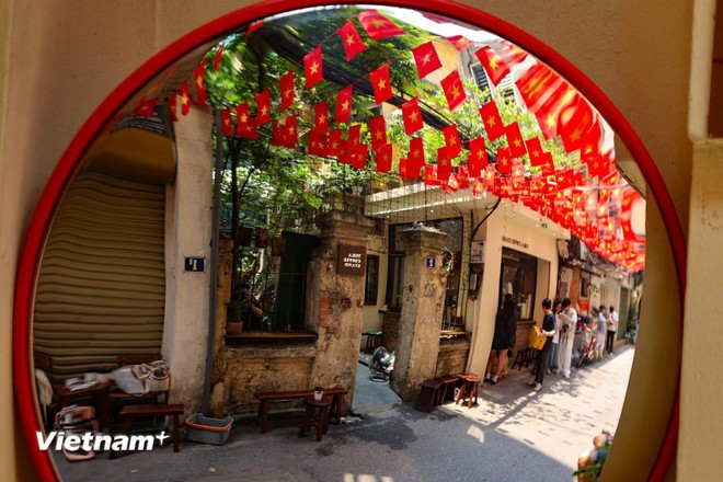 Un pequeño callejón en el distrito de Hoan Kiem siempre está lleno de jóvenes que se detienen a capturar momentos del ambiente de la conmemoración del 50 aniversario de la Liberación del Sur y la Reunificación Nacional. (Foto: VNA)