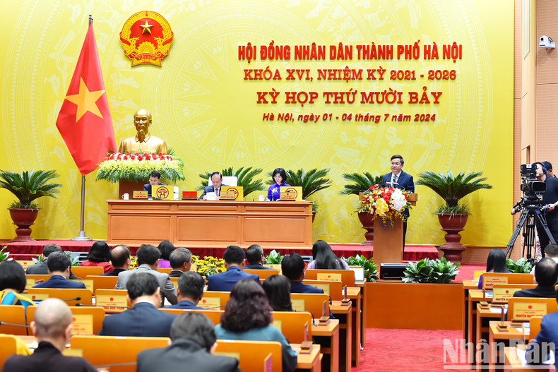 El vicepresidente del Comité Popular de Hanói, Ha Minh Hai, presenta el informe sobre los resultados de la implementación del plan de desarrollo socioeconómico, los ingresos y gastos presupuestarios en los primeros seis meses de 2024 y las tareas clave en los meses restantes del año.