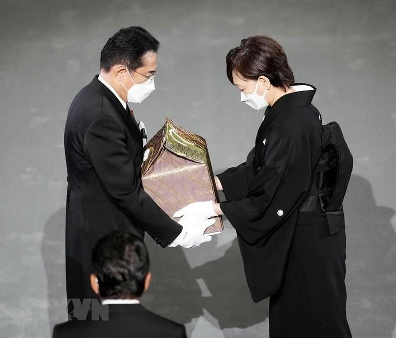 La esposa de Shinzo Abe, Abe Akie, entrega las cenizas de su fallecido esposo al primer ministro Kishida Fumio. (Fotografía: AFP/VNA)