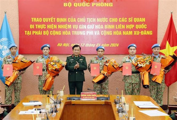 El coronel general Hoang Xuan Chien entrega la Decisión del Presidente sobre el envío de cinco oficiales a las misiones de paz de las Naciones Unidas. (Foto: VNA) El coronel general Hoang Xuan Chien entrega la Decisión del Presidente sobre el envío de cinco oficiales a las misiones de paz de las Naciones Unidas. (Foto: VNA)