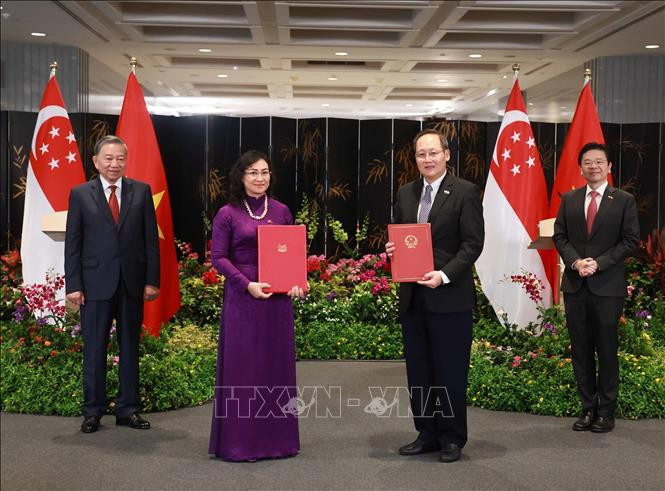 To Lam y Lawrence Wong son testigos del intercambio de firmas del Informe Conjunto sobre la Cooperación Comercial en Energía Eólica Marina entre Vietnam y Singapur. (Foto: VNA) To Lam y Lawrence Wong son testigos del intercambio de firmas del Informe Conjunto sobre la Cooperación Comercial en Energía Eólica Marina entre Vietnam y Singapur. (Foto: VNA)