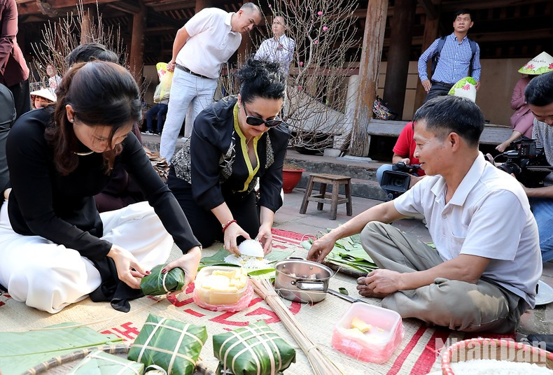 Los visitantes hacen banh chung (pastel cuadrado de arroz glutinoso). Los visitantes hacen banh chung (pastel cuadrado de arroz glutinoso).