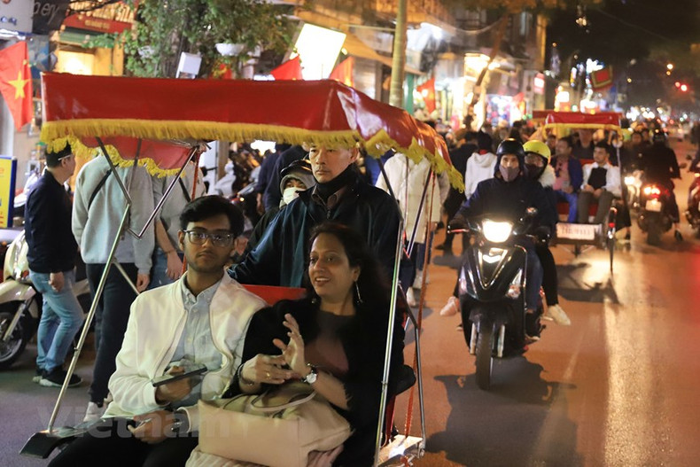 Grupos de turistas extranjeros optan por recorrer las calles de Hanói en triciclos el último día del año.