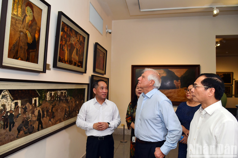 Los delegados observan las pinturas en el museo.
