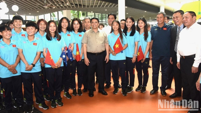 El primer ministro Pham Minh Chinh y el cuerpo técnico y las jugadoras de la selección vietnamita de fútbol femenino.