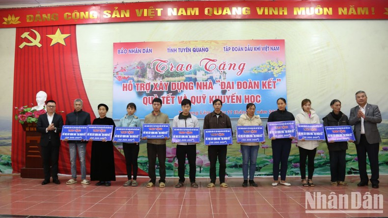 Ejecutivos de Nhan Dan y del Grupo Petrovietnam entregan simbólicamente apoyo a 10 familias necesitadas y beneficiarias de políticas sociales en la comuna de Thuong Lam.