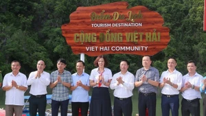 Los delegados realizan la ceremonia de colocación del cartel del Sitio de Turismo Comunitario de Viet Hai. (Foto: VNA)