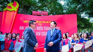 El viceprimer ministro Mai Van Chinh (derecha) visita la exposición “Textos completos de los borradores de documentos del XIV Congreso Nacional del Partido” en la sede de Nhan Dan.