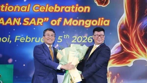 El viceministro permanente de Relaciones Exteriores, Nguyen Minh Vu, entrega flores para felicitar al embajador de Mongolia en Vietnam, Jigjee Sereejav. (Foto: VNA)