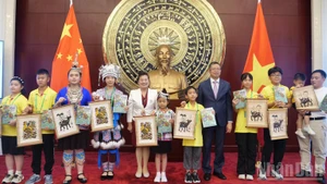 El embajador Pham Thanh Binh se toma una foto de recuerdo con niños chinos.