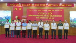 Entregan certificados de mérito a personas destadas en el programa de eliminación de viviendas precarias en Lao Cai, el 19 de junio. (Foto: VNA)