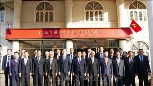 Delegados vietnamitas y laosianos participantes en el evento (Foto: VNA)