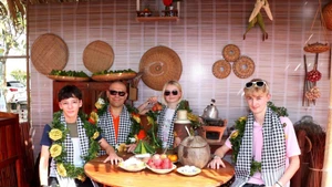 Turistas extranjeros degustan especialidades del Sur de Vietnam. (Foto: VNA)