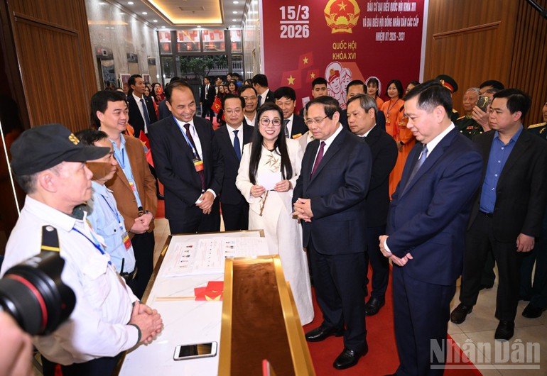 El primer ministro de Vietnam, Pham Minh Chinh, y su cónyuge con votantes en el colegio electoral número 21, ubicado en el barrio de Tay Ho, en Hanói.