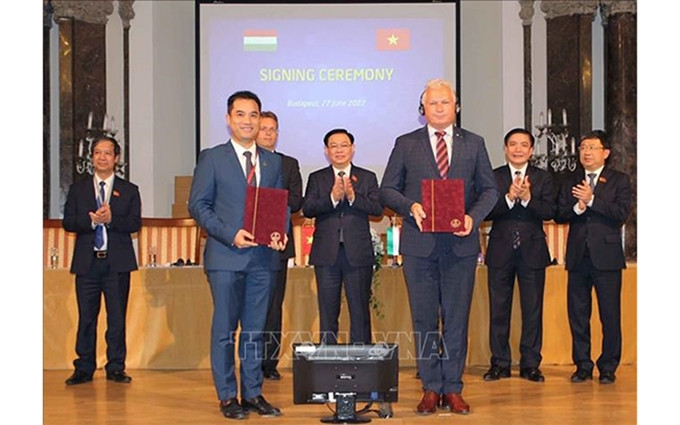 El presidente de la Asamblea Nacional de Vietnam, Vuong Dinh Hue, presencia la firma de acuerdos de cooperación. (Fotografía: VNA) 