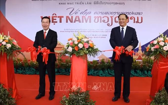 Vo Van Thuong, miembro del Buró Político y permanente del Secretariado del Comité Central del Partido Comunista de Vietnam, y Sonexay Siphandone, viceprimer ministro de Laos, cortan la cinta para inaugurar la exposición. (Fotografía: VNA)