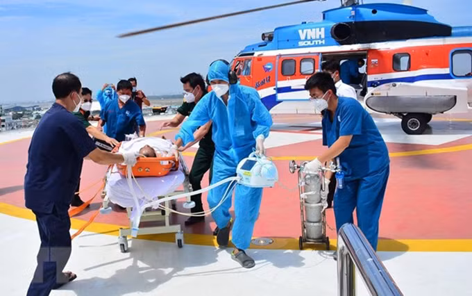 Trasladan a pacientes desde el helicóptero al Hospital Militar 175. (Fotografía: VNA)