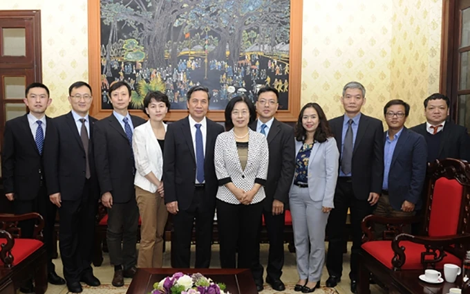 Delegación del Renmin Ribao (Diario del Pueblo), de China, toma foto de recuerdo con representantes del periódico Nhan Dan (Pueblo), de Vietnam. 