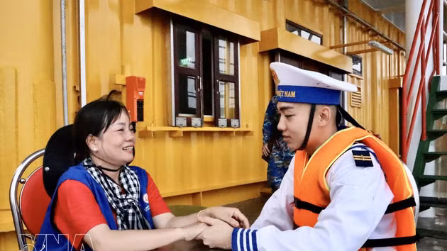 El militar Nguyen Pham Nhat Khuong y su madre aprovecharon un breve lapso para interesarse por la salud y el trabajo de cada uno en la plataforma DK1/10. (Foto: VNA)