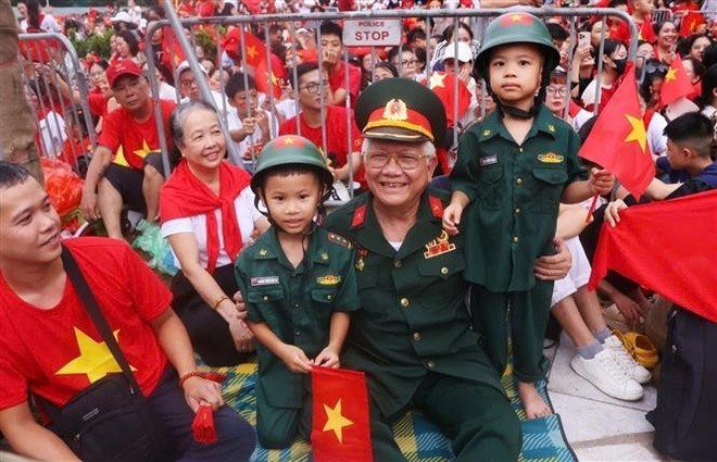 Un veterano y niños llegan temprano para presenciar el segundo ensayo. (Foto: VNA) Un veterano y niños llegan temprano para presenciar el segundo ensayo. (Foto: VNA)