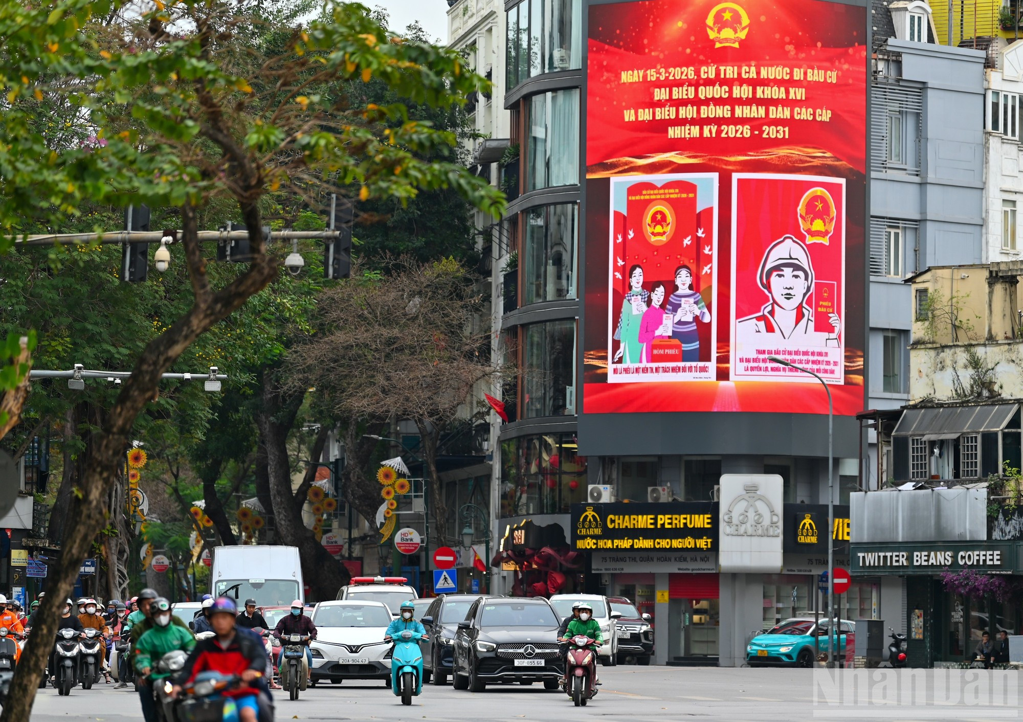 Las grandes avenidas de Hanói, como Dien Bien Phu, Trang Tien y Hang Bai, se engalanan con banderas nacionales, pancartas y paneles propagandísticos, creando un ambiente vibrante en vísperas de las elecciones.