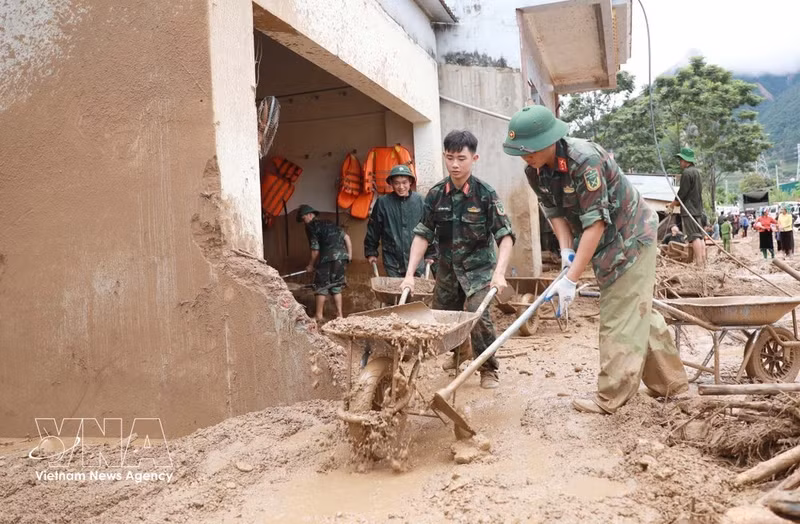 Miembros de las fuerzas armadas ayudan a los residentes de la comuna de Muong Than, provincia de Lai Chau, a recuperarse de las inundaciones y los deslizamientos de tierra. (Foto: VNA)
