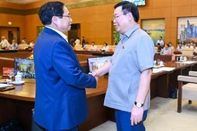 El secretario del Comité de Asuntos partidistas y primer ministro del Gobierno, Pham Minh Chinh, y el secretario del Comité de Asuntos partidistas y presidente de la AN, Vuong Dinh Hue, en la reunión. 