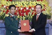 El presidente vietnamita, Vo Van Thuong, entrega la decisión de ascenso al rango militar del coronel general a Nguyen Van Nghia, subjefe del Estado Mayor General del EPV. (Fotografía: VNA)