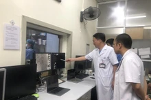 Los médicos evalúan un caso antes de la intervención. (Fotografía: VNA)