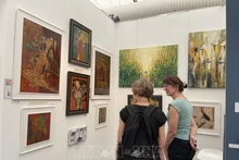 El rincón de pintura lacada del artista Phuong Binh atrae a muchos espectadores. (Foto: VNA)