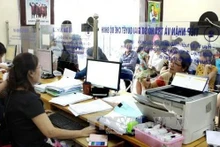 Solución de procedimientos sobre seguros sociales y seguros de salud en el Seguro Social del distrito de Cau Giay. (Fuente: VNA)
