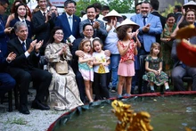 El primer ministro Pham Minh Chinh, su esposa y otros delegados disfrutan de un espectáculo de marionetas de agua en el evento. (Fotografía: VNA)